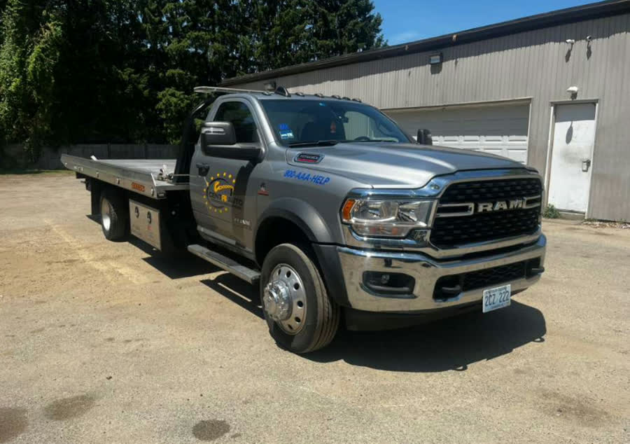 Silver Ram 5500 flatbed parked at the yard