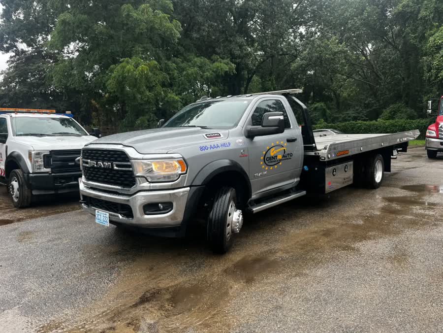 Silver Ram 5500 flatbed on a wet morning