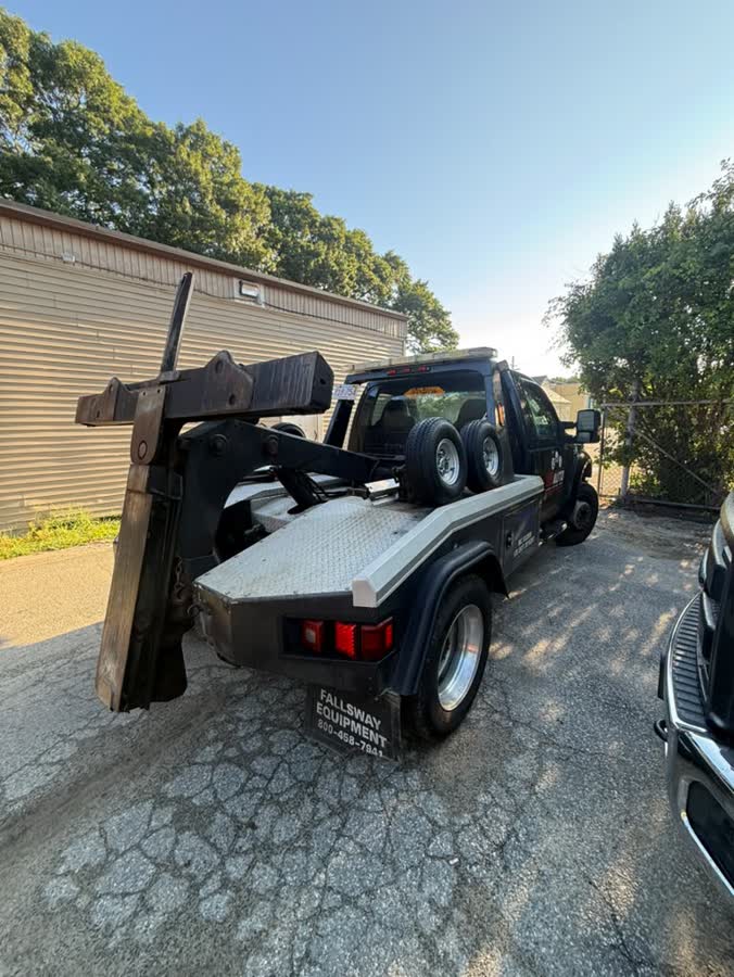 The black wrecker with its boom raised
