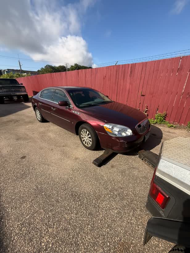 Maroon sedan on the flatbed