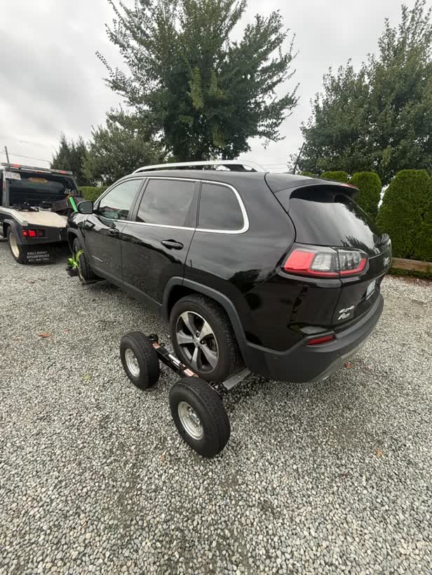 Black SUV on dollies, rear view